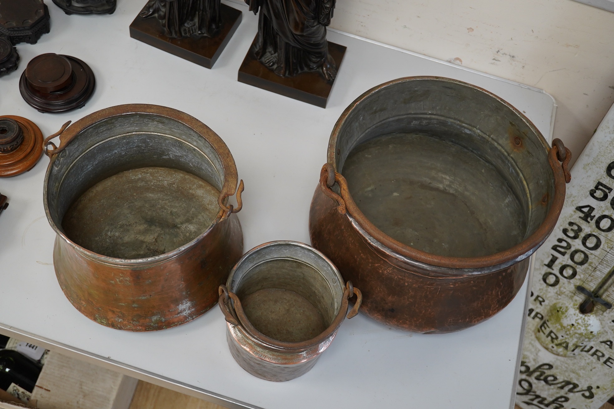 A set of three graduated coppered buckets with swing handles. Largest 22cm high. Condition - fair